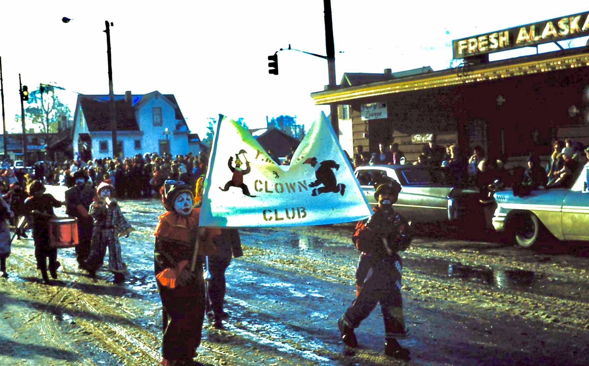 The Anchorage Clown Club delights the crowd during the Fur Rondy in Anchorage, Alaska in 1963 or 64. 1963 or 64 fur rendezvous parade
