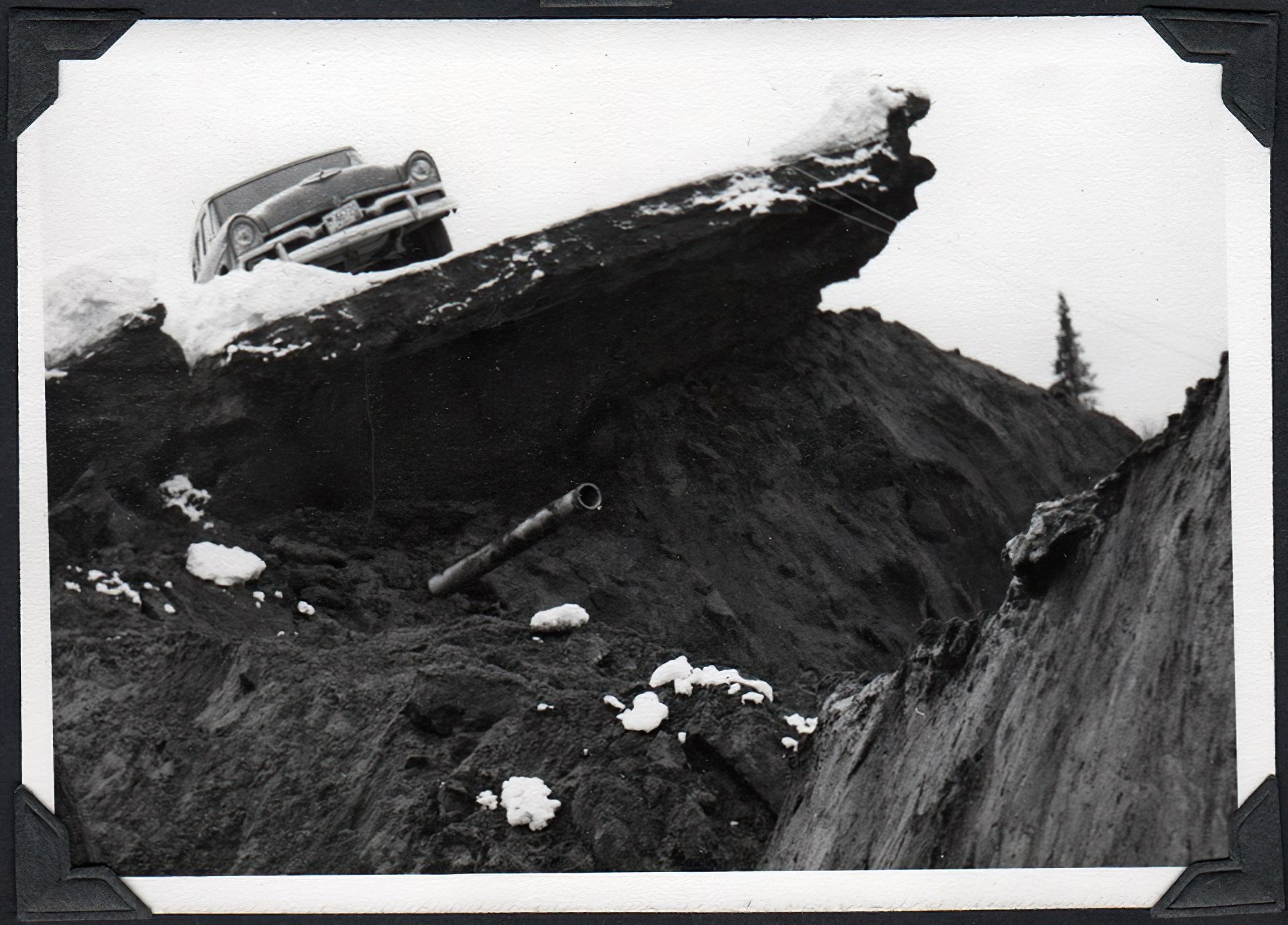 car sitting on top of earthquake damage